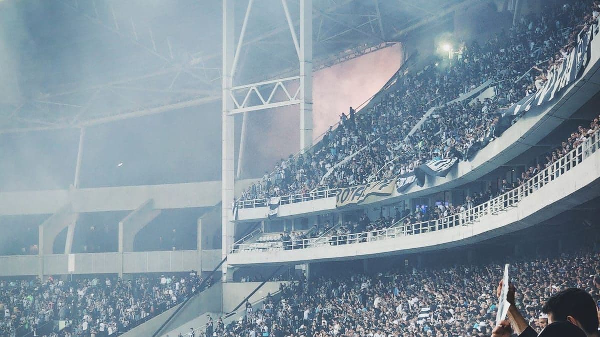 Soccer fans packed into a stadium watching a match